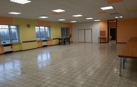 Vista del salone con tavoli e sedie pronti per un evento